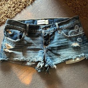 Abercrombie distressed, medium white shorts with rose embroidered size 16